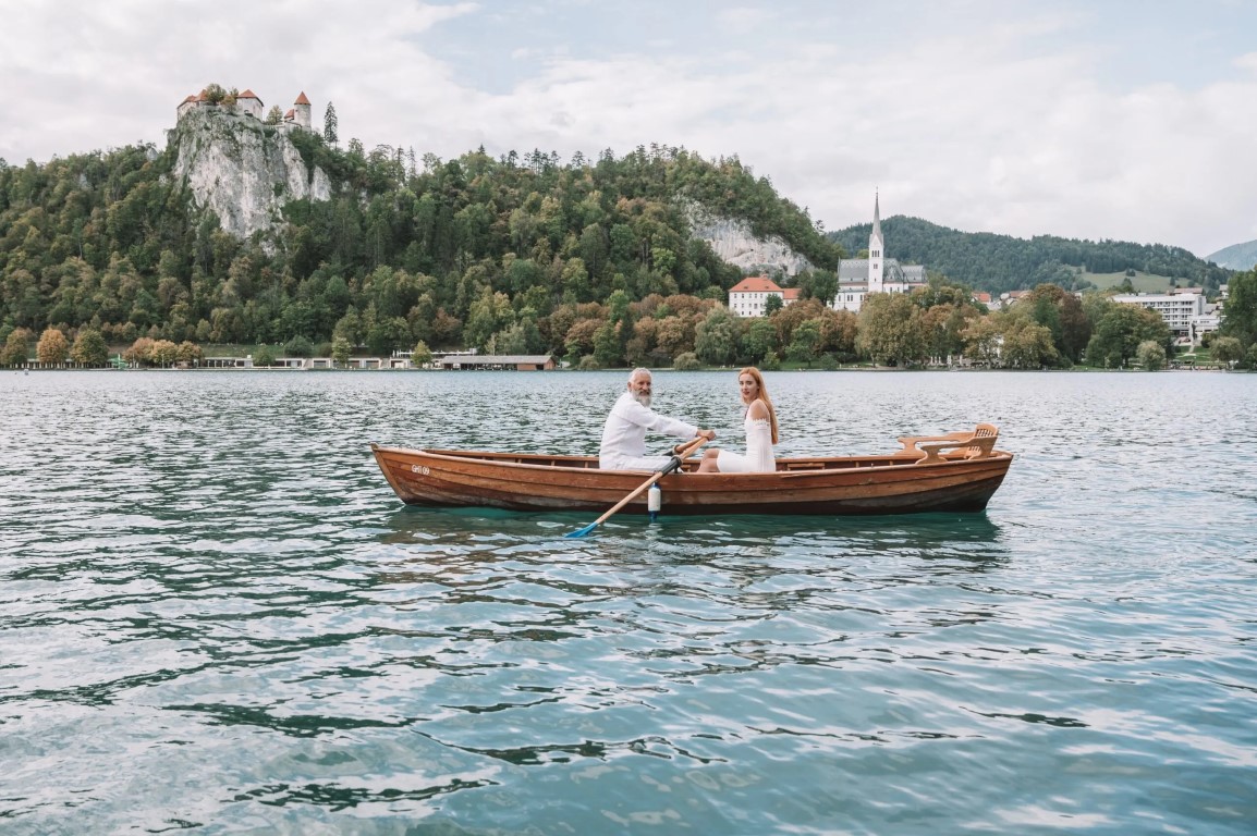 Elegant wedding photography at Lake Bled with alpine backdrop